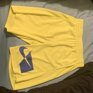 Green and yellow Nike running shorts